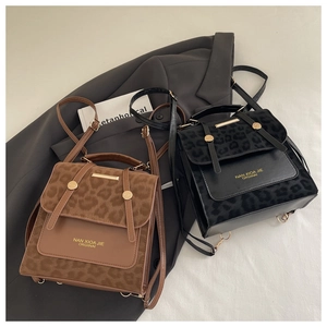 Close-up of leopard print and leather paneling on stylish retro women backpack