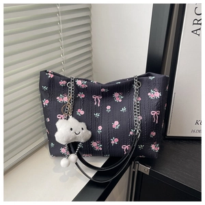 Detail of floral tote bag with silver chain strap and cute cloud plush pendant
