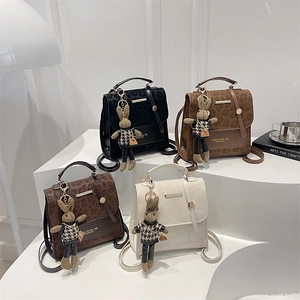 Chic leopard print backpacks in four colors with cute rabbit pendants on display