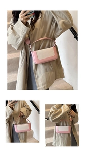 Detail view showing pink leather and beige woven fabric textures on the rectangular box bag