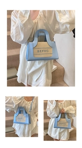 Detail of light blue crossbody bag with BEPRO embroidery and elegant top handle