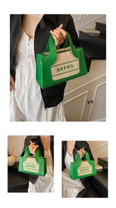 Detailed shot of BEPRO green embroidery on a canvas and leather tote bag with dual handles