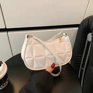 Modern white quilted underarm bag with triangular geometric stitching and gold zipper