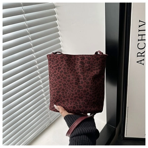 Detail of burgundy leopard print bucket bag made of soft faux suede material