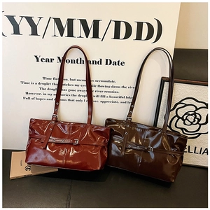 Detail of red-brown and coffee vintage tote bags with shiny patent leather and buckle