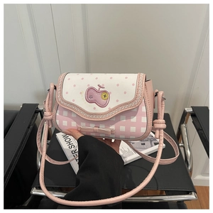 Detail shot of the pink plaid crossbody bag featuring an apple patch and bow decoration