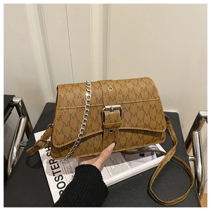 Close-up of brown monogram crossbody bag with silver chain strap and metal buckle