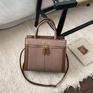 Brown herringbone fabric and leather crossbody bag with dual handles and gold logo detail