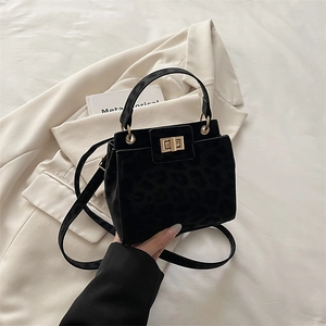 Large black leopard embossed suede tote bag with golden twist lock and shoulder strap