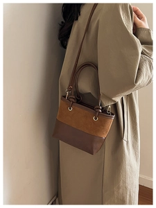 Close-up of vintage patchwork bucket bag featuring suede and leather texture detail