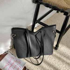 Large capacity black denim tote bag with white contrast stitching and metal rivet details