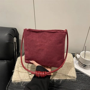 Burgundy suede shoulder bag with letter embossing and unique knotted strap for women