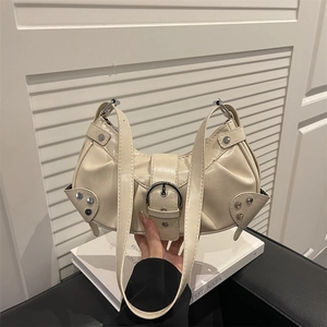 Cream pleated crescent shoulder bag with silver metal buckles and stud detailing