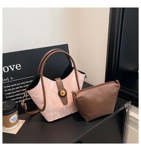 Detail of pink marble textured bucket bag with amber twist lock and inner pouch