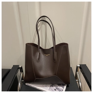 Detail of dark coffee PU leather tote bag featuring gold embossed lettering on the front