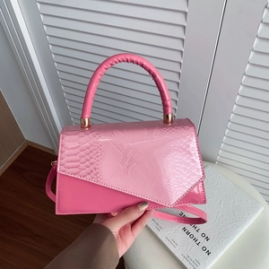 Pink patent leather handbag with snakeskin texture flap and crossbody strap