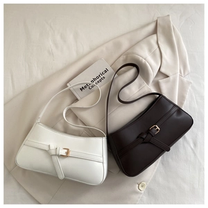 Close-up of minimalist retro underarm bags in white and dark coffee with gold buckles