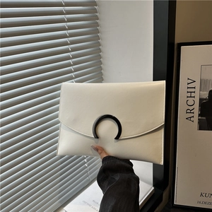 Minimalist white leather envelope clutch bag with unique black crescent metal buckle