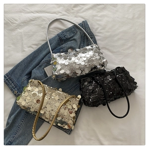 Detailed view of sequined baguette bags in gold, silver and black with metallic finish