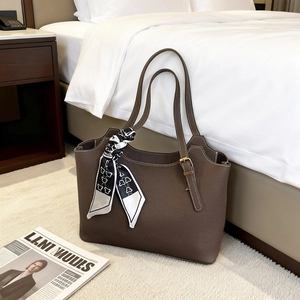Deep brown lychee pattern leather tote bag with a decorative printed silk scarf on handle