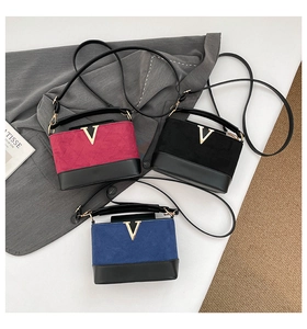 Quilted suede crossbody bags in rose, black and blue with golden V hardware detail