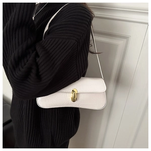 Chic white crocodile pattern baguette bag with gold metal buckle shown on a model