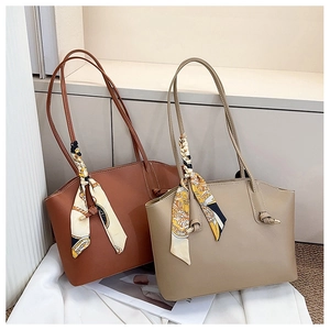 Detail of minimalist tote bags in brown and khaki with vintage floral silk scarves