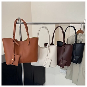 Detail view of large tote bags in four colors with matching small envelope pouches