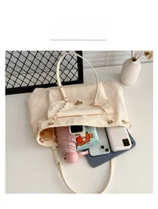 Interior view of beige textured tote bag showing large capacity for laptop and daily items