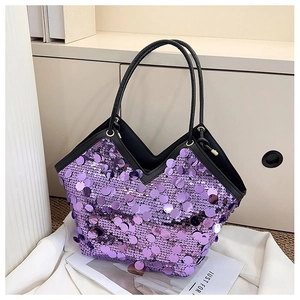 Close-up of purple large sequins on bucket bag with black leather handles detail