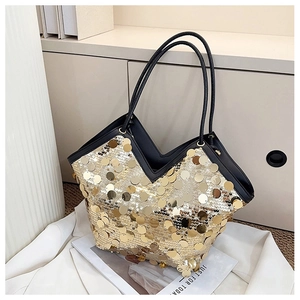 Close-up of shiny gold sequins and V-shaped opening on a large fashion tote bag