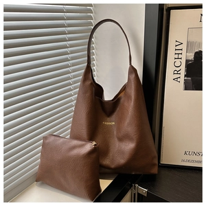Detailed view of brown faux leather tote set with FASHION lettering and matching pouch