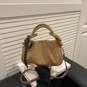 Retro brown suede handbag with heart charm and striped ribbon in a stylish urban look
