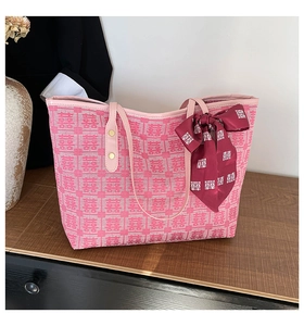 Close-up of pink tote bag with traditional Double Happiness jacquard and red silk scarf