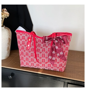 Macro detail of red bridal canvas tote bag with silk scarf and Xi character jacquard pattern