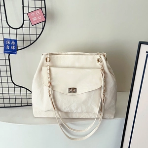 Chic cream white leather tote bag with chain strap and elegant gold twist lock closure