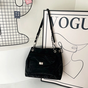Large black pleated velvet tote bag with chain strap and gold lock for commuting