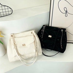 Large capacity leather tote bags in cream and black with metal chain straps and gold clasps