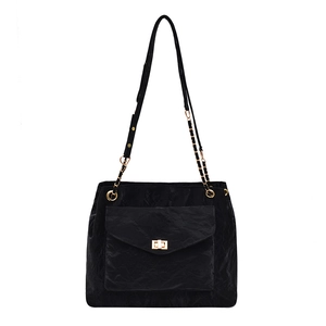 Large black tote bag with crinkled texture, gold chain strap, and turn-lock closure