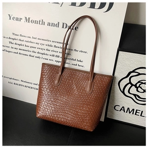 Close-up of brown woven texture on large tote bag with durable synthetic leather finish