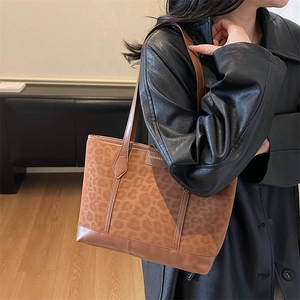 Large leopard print tote bag with brown leather handles for autumn fashion