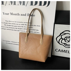 Detailed close-up of camel woven texture tote bag showing refined minimalist craftsmanship
