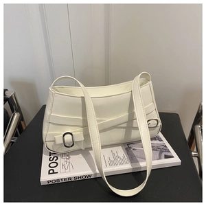 Detail of white leather shoulder bag with cross straps and silver metal buckle