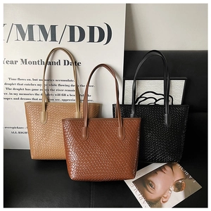 Detailed view of woven texture tote bags in beige, brown, and black stylish variants