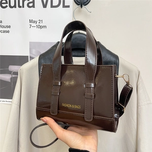 Brown patent leather square crossbody bag with top handles and fashion lettering