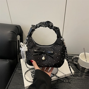Black lace crescent handbag with silver studs, pearl charms and bow detail on handle