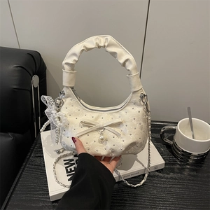 Creamy white bow handbag with pearls, floral texture and silver chain strap