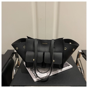 Detail of black lychee grain tote bag with multi-pockets and gold rivet accents