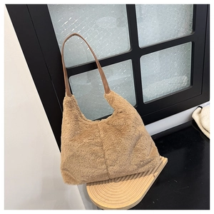 Detailed view of the fuzzy brown plush tote bag with a sleek leather strap and hobo shape