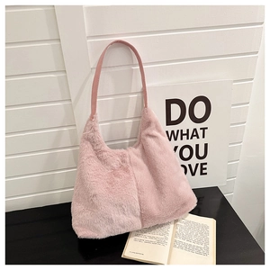 Detail of the soft pink faux fur texture and leather handle on this elegant hobo bag